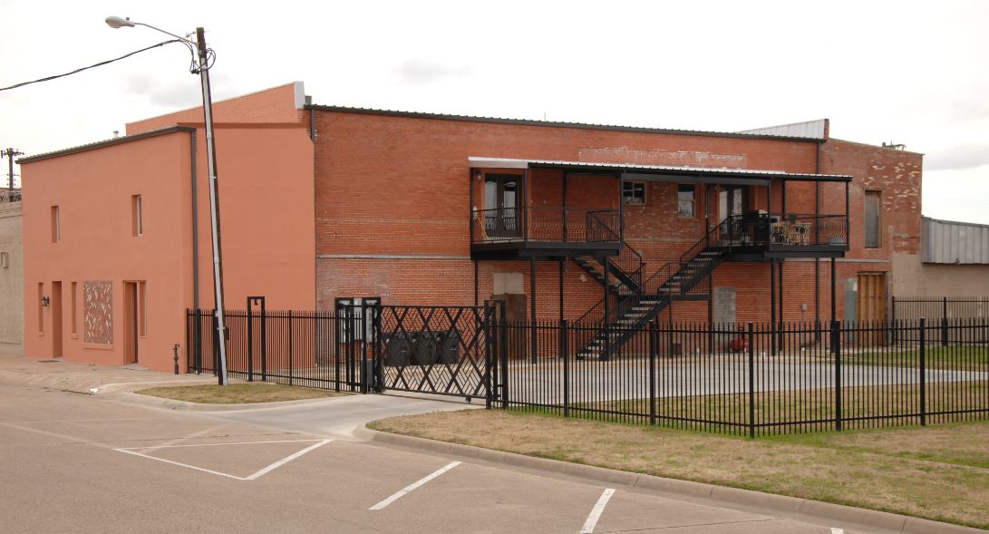 Exterior of brick building with fence and staircases